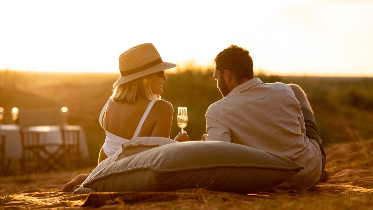 Coupe enjoying sundowners on the dune